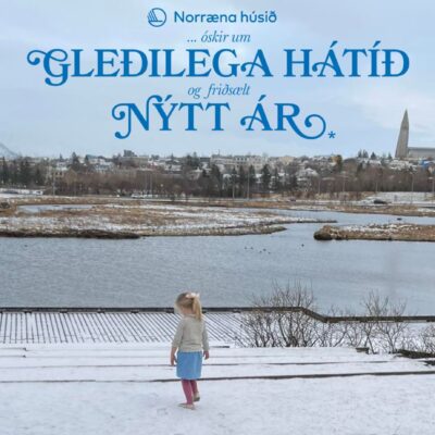 little girl walks in the snow and frost infront of a pond. In the distance you see a big church.