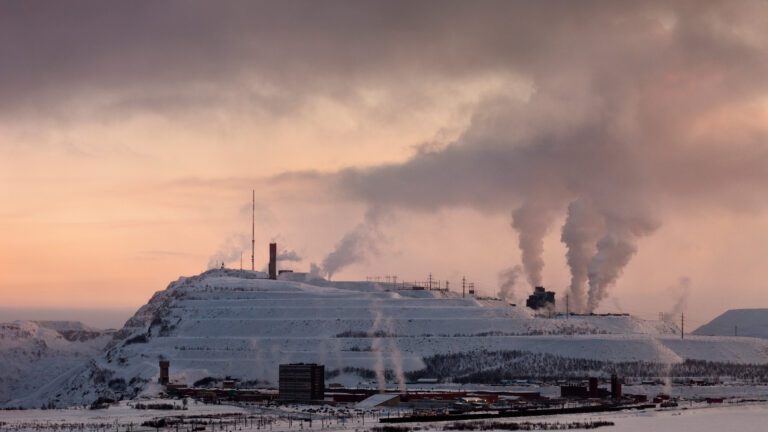 Photo Artwork by Marja Helander. A view of a factory in Kiruna, Sweden, Smoke rises from several chimneys.