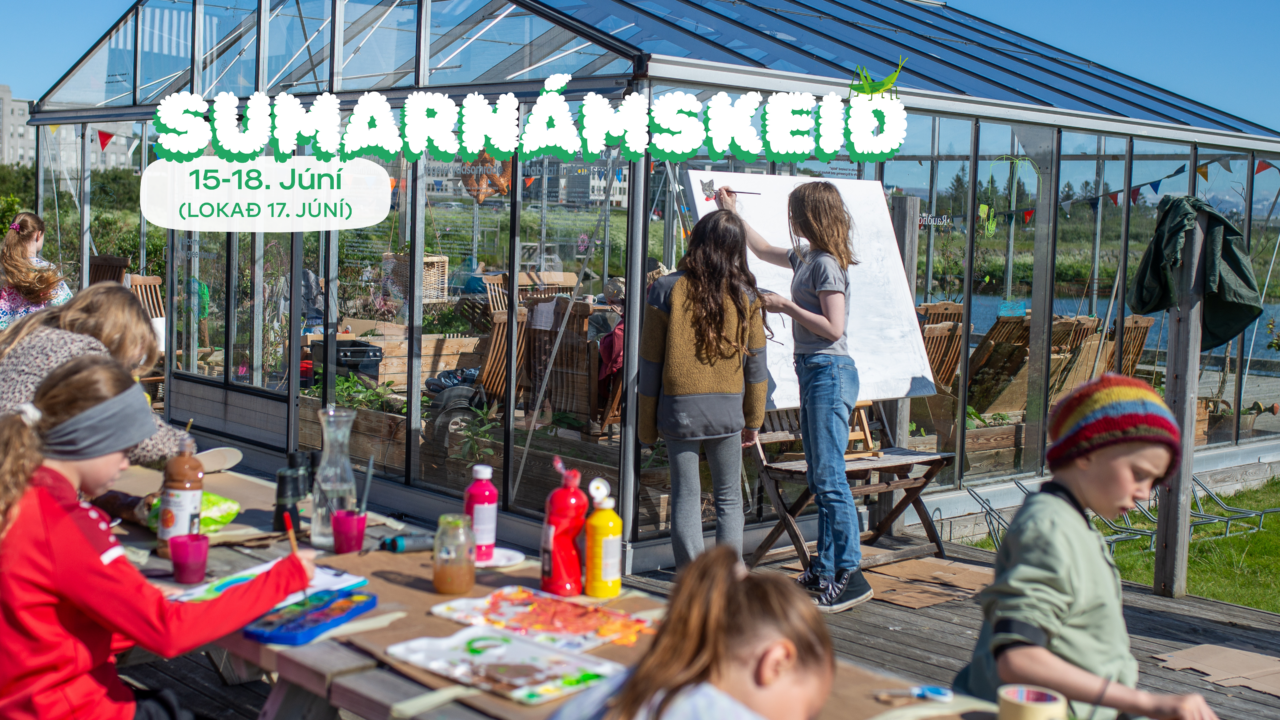 Outdoor picture of children's next to a greenhouse painting and being creative.