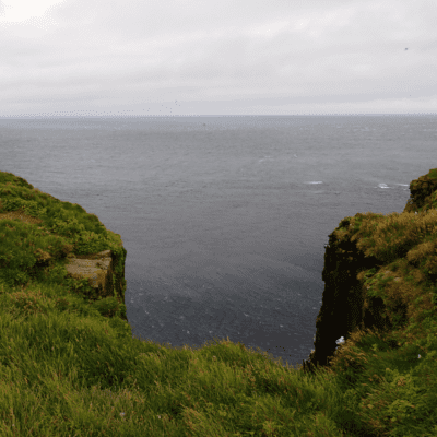picture of the view out towards sea with cliffs in the foreground