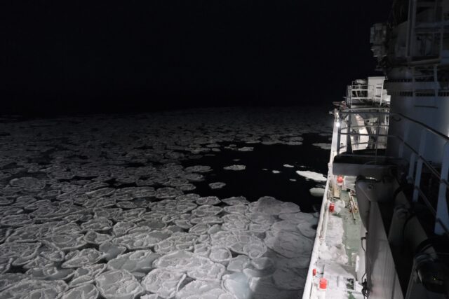photo taken on a ship out on sea. Dark sea and sky.