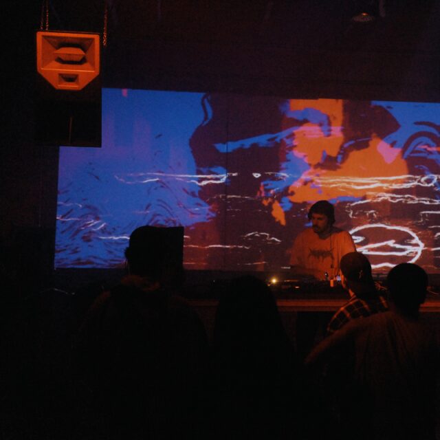 Ukrainian DJ and cultural organizer Oles Zazulin - photo in color, primarily blue and red