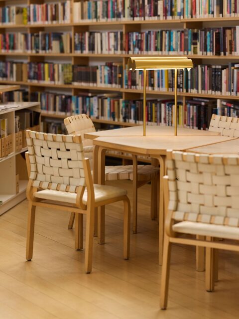 Reading tables with brass lamps, in the Nordic House library