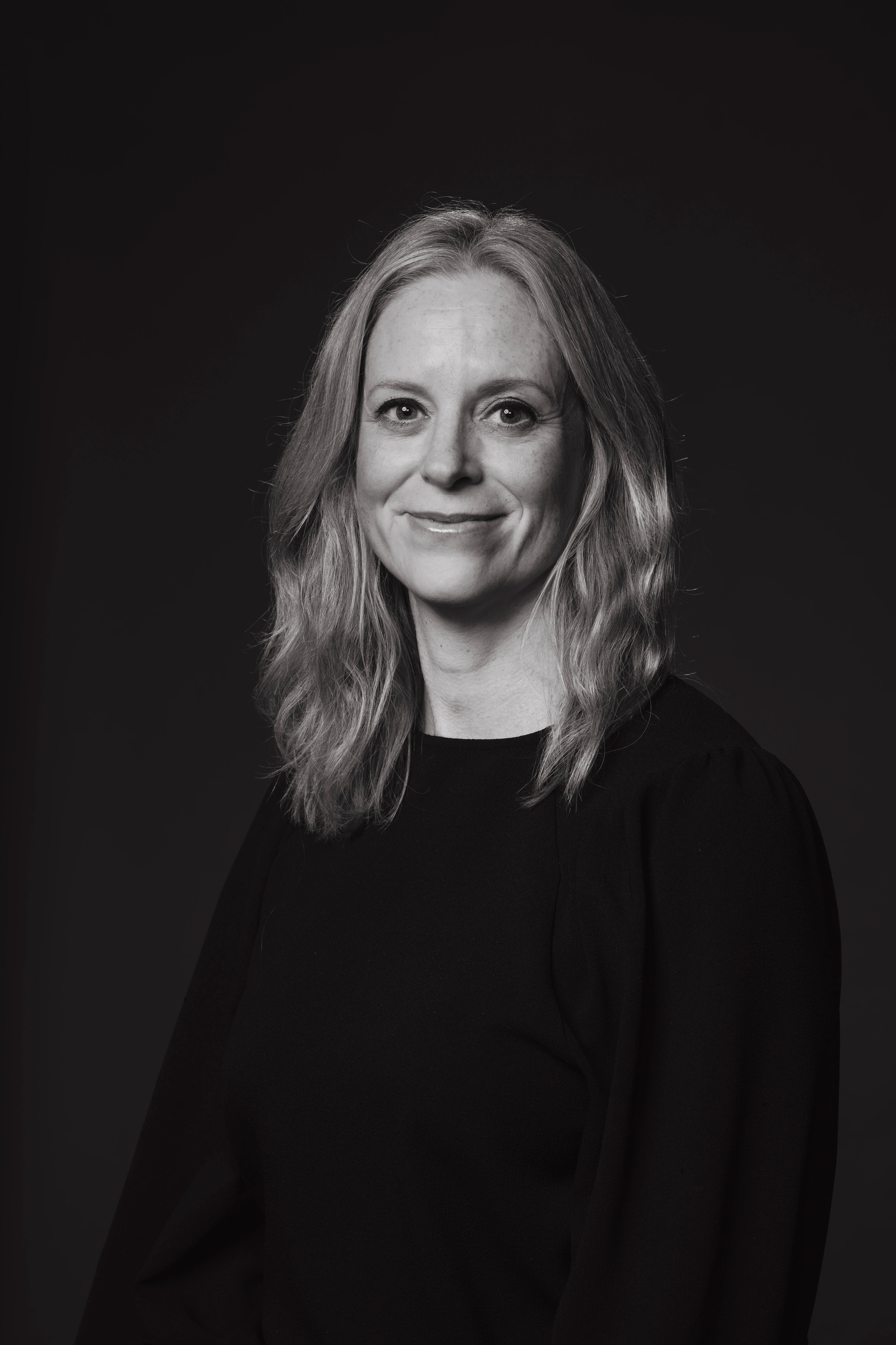 Black and white portrait of a blond woman.
